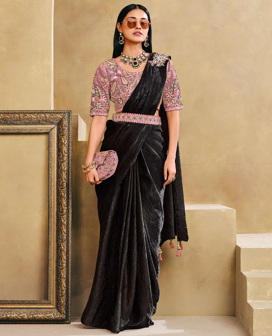 Black Plain Party Wear Designer Saree, Complemented with a Contrast Round Neck Heavy Embroidered Elbow Sleeve Readymade Blouse, Detachable Embroidered Belt, and a Free Embroidered Flap Sling Bag