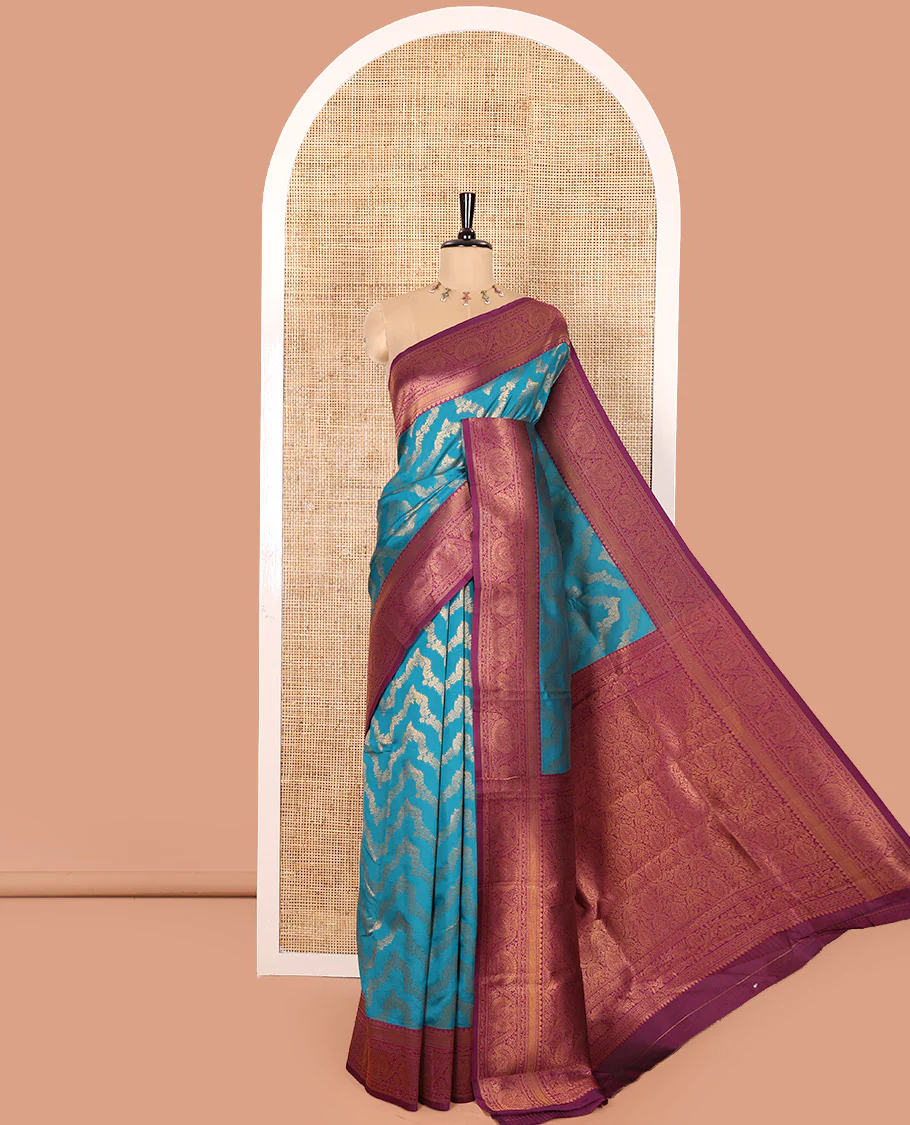 Blue Kanchi Silk Saree Mesmerized with Floral Jacquard Design All Over Its Body, Complemented by a Contrast Traditional Zari Border of Floral Creeper Designs, an Opulently Embellished Pallu, and Paired with a Contrast Jacquard Blouse