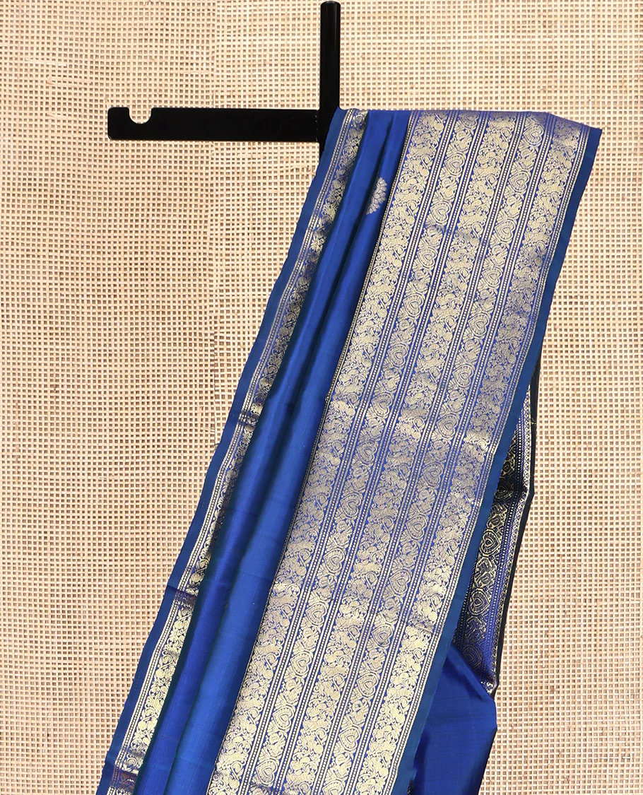 Blue Kanchipuram Silk Saree, Decorated with Zari Buttas All Over Its Body, Highlighted by a Zari Border of Salngai, Muthu, Mayil, and Kuthirai Designs, Grand Jaal Pallu, and Paired with a Matching Blouse - Image 3