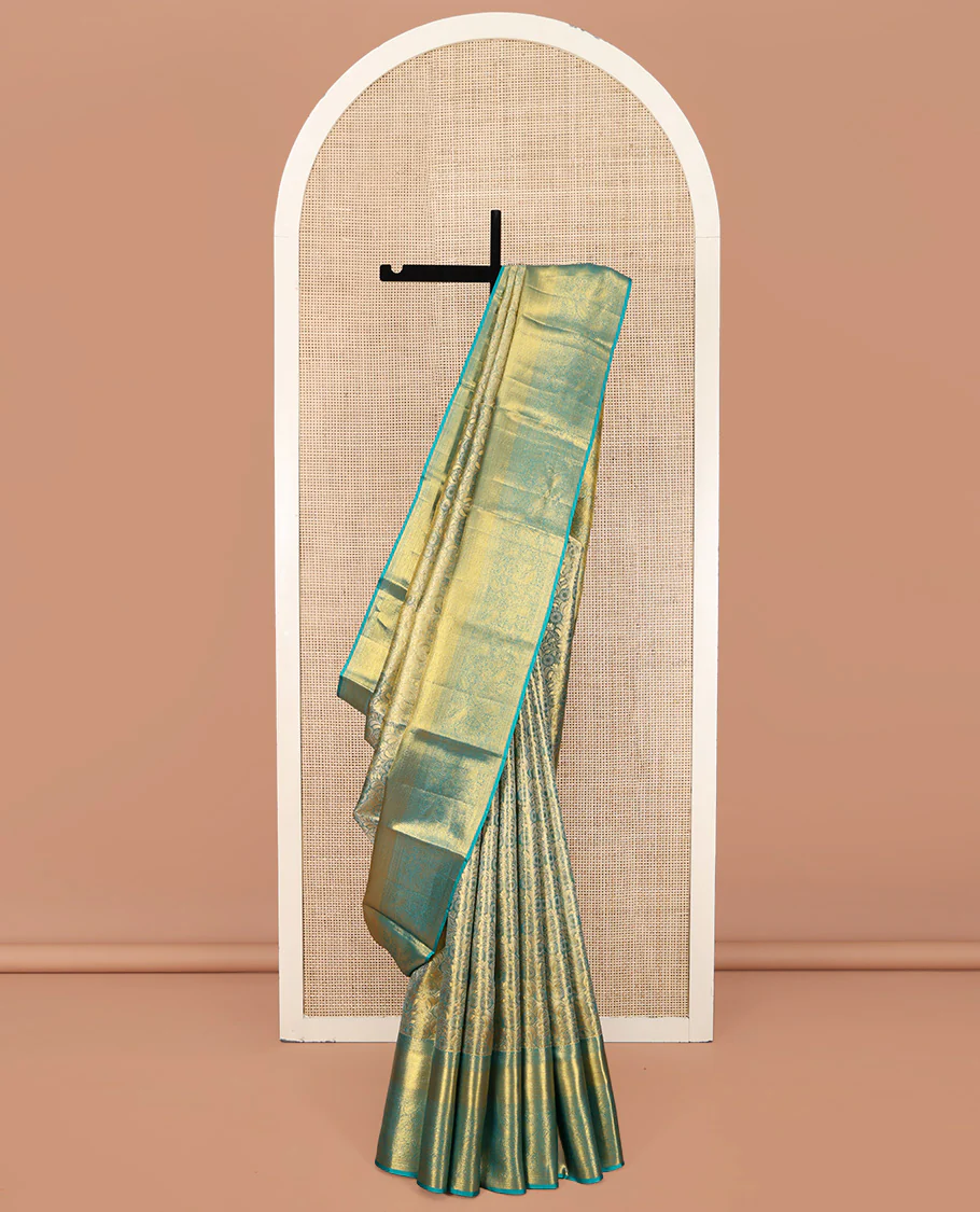 Blue Kanchipuram Silk Saree, Elegantly Highlighted with Zari Jacquard Design All Over Its Body, Highlighted by a Zari Border of Thilakam Mokku, Muthu, Mayil Kann, and Manga Designs, and Pallu of Mughal-Style Designs, and Paired with a Matching Blouse