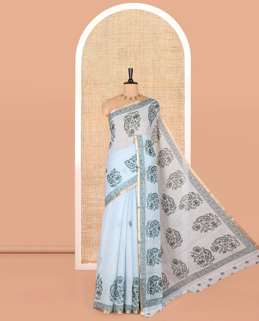 Blue Linen Cotton Saree, Artfully Designed with Floral-Paisley Motifs Print All Over Its Body, Highlighted by Gold Zari Printed Border, Floral-Paisley Printed Pallu and Paired with a Matching Blouse