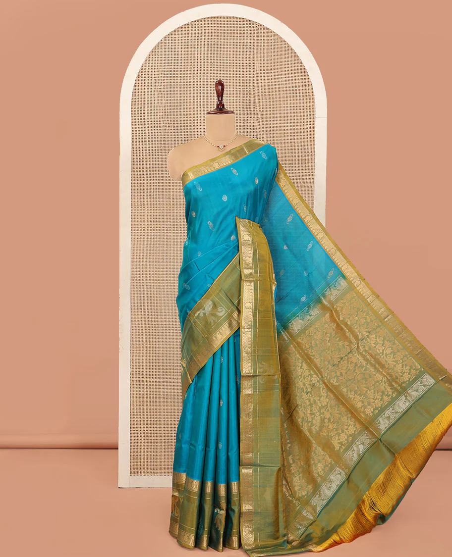 Blue Uppada Silk Saree Graced with Zari Buttas, Complemented by a Contrast Traditional Zari Border of Peacock Veena Designs, Contrast Pallu of Floral Jaal Designs, and Paired with a Contrast Blouse