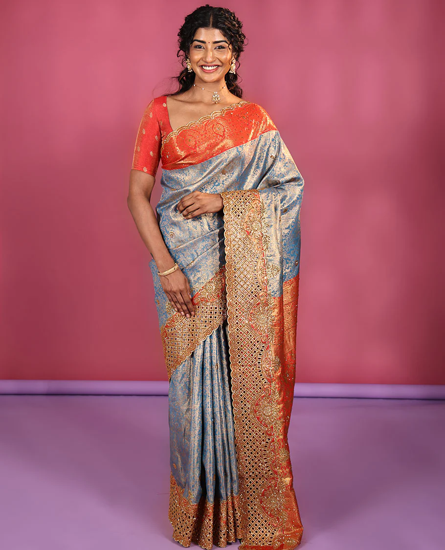 Blue Vastrakala Silk Saree, Adorned with Floral Jacquard and Stone Work, Complemented by Contrast Traditional Zari and Cut Embroidered Scallop Border, Gleaming Grand Zari-Stone Work Pallu, and Paired with Contrast Heavy Stone Embroidered Blouse
