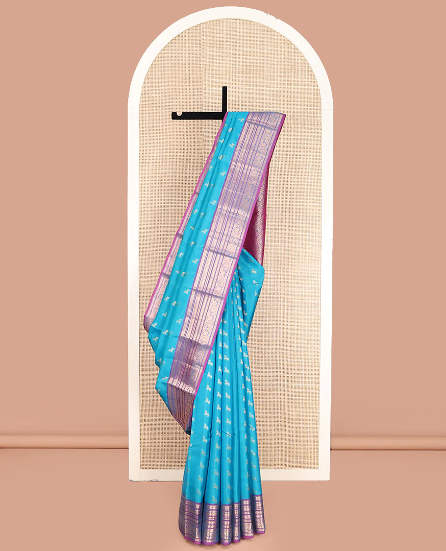 Blue Vasundhara Lite-Silk Mix Saree, Featuring Deer Buttas All Over Its Body, Complemented by a Contrast Border of Thilakam Mokku, Muthu, Kamalam, Neli, Manga, and Kodi Visiry Designs, Opulently Embellished Pallu, and Paired with a Contrast Blouse