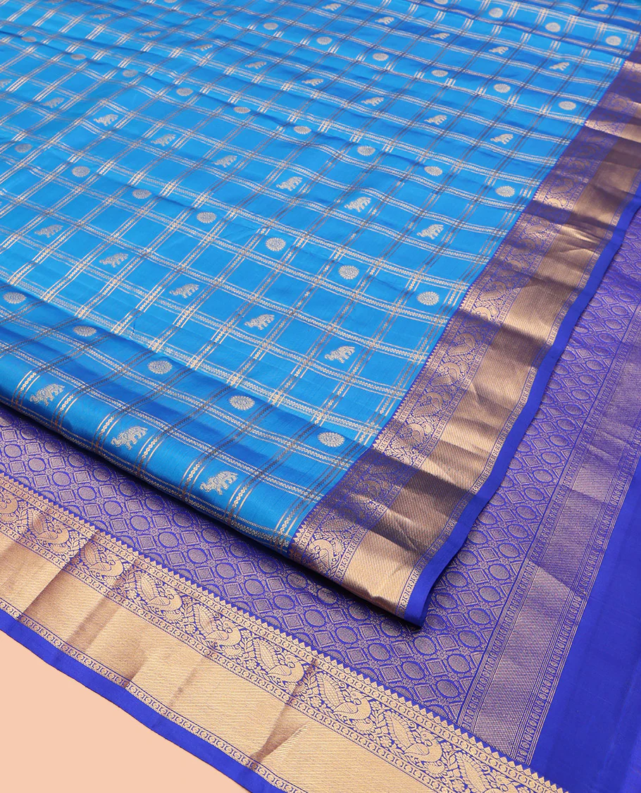 Blue Vasundhara Lite-Silk Mix Saree, Spotlighted with Yaanai, and Chakram Butta Enclosed Checks, Complemented by a Contrast Border of Thilakam, Poun, and Mayil Designs, Pallu Highlighted by Geometric Designs, and Paired with a Contrast Blouse - Image 3