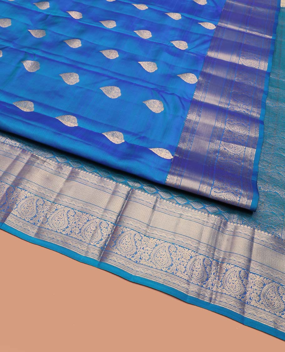Blue Vasundhara Silk Saree, Mesmerized with Zari Buttas on Its Body, Highlighted by a Zari Border of Manga Mokku, Muthu, and Arumbu Manga Designs, Pallu Steeped with Leaf Designs, and Paired with a Matching Blouse - Image 2