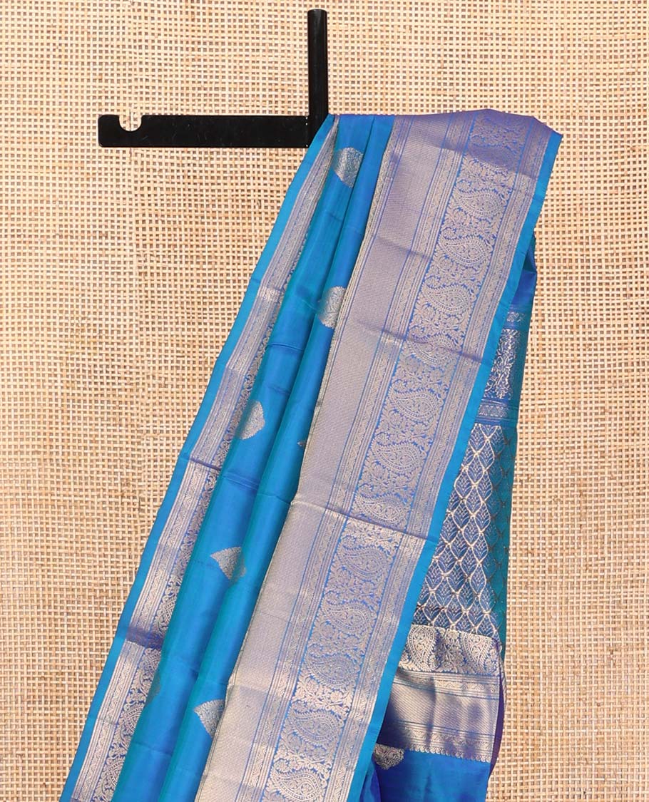 Blue Vasundhara Silk Saree, Mesmerized with Zari Buttas on Its Body, Highlighted by a Zari Border of Manga Mokku, Muthu, and Arumbu Manga Designs, Pallu Steeped with Leaf Designs, and Paired with a Matching Blouse - Image 3