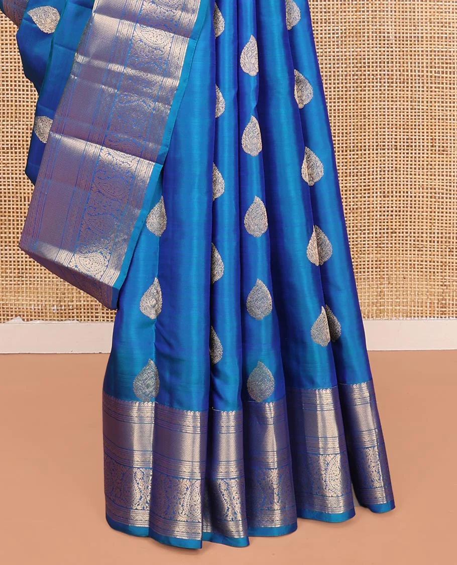 Blue Vasundhara Silk Saree, Mesmerized with Zari Buttas on Its Body, Highlighted by a Zari Border of Manga Mokku, Muthu, and Arumbu Manga Designs, Pallu Steeped with Leaf Designs, and Paired with a Matching Blouse - Image 4