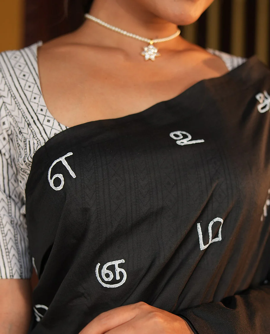 Borderless Black South Cotton Saree, Adorned with Tamil Letters Printed on Its Body, a Self-Pallu, and Comes with a Matching Blouse, and a Contrast Printed Blouse - Image 3