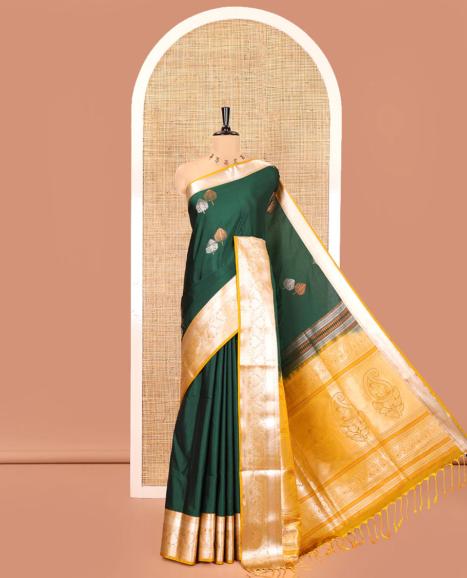 Bottle Green Semi-Soft Silk Saree, Detailed with Zari Buttas All Over Its Body, Complemented by a Contrast Traditional Zari Design Border, Intricately Designed Pallu, and Paired with a Contrast Blouse