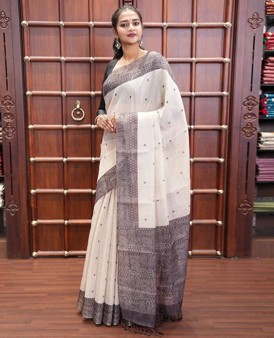 Chikku and Black Tissue Linen Saree, Delicately Printed with Floral Motifs on Its Body, Complemented by a Contrast Border of Paisley Designs, Pallu Steeped with Paisley Designs, and Paired with a Contrast Blouse - Image 2
