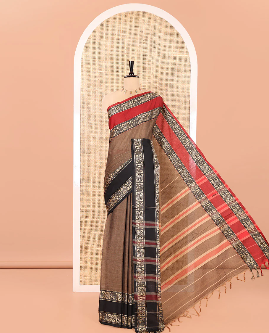 Chikku Plain Mercerised Cotton Saree, Complemented by a Contrast Ganga-Jamuna Rettai Pettu Thread Border of Temple, Elephant, and Chakram Designs, Subtly Striped Pallu, and Paired with a Matching Blouse
