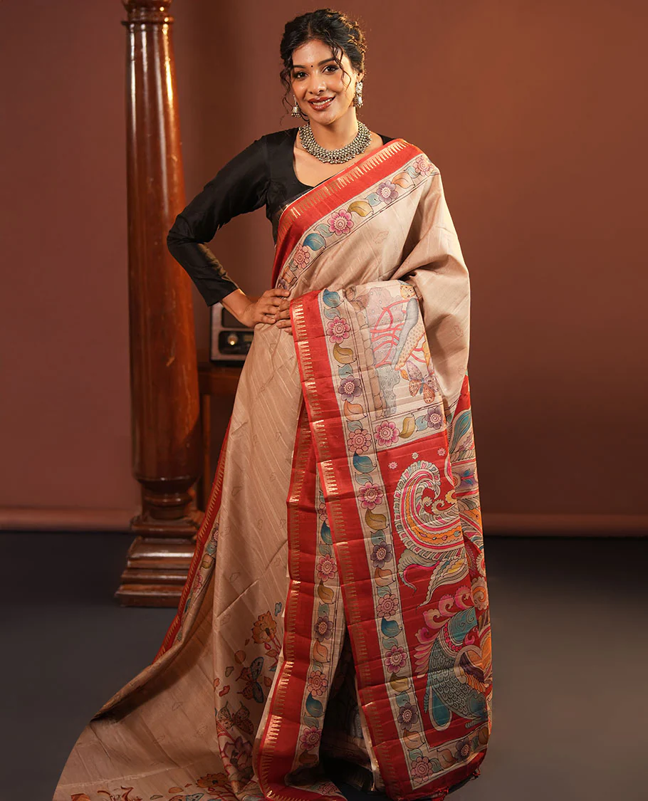 Chikku-Red Fancy Tussar Saree, Artfully Detailed with Kalamkari-Style Floral Print Across Its Body, Complemented by Contrast Temple Zari Border, a Colourfully Kalamkari Printed Pallu, and Paired with a Plain Blouse
