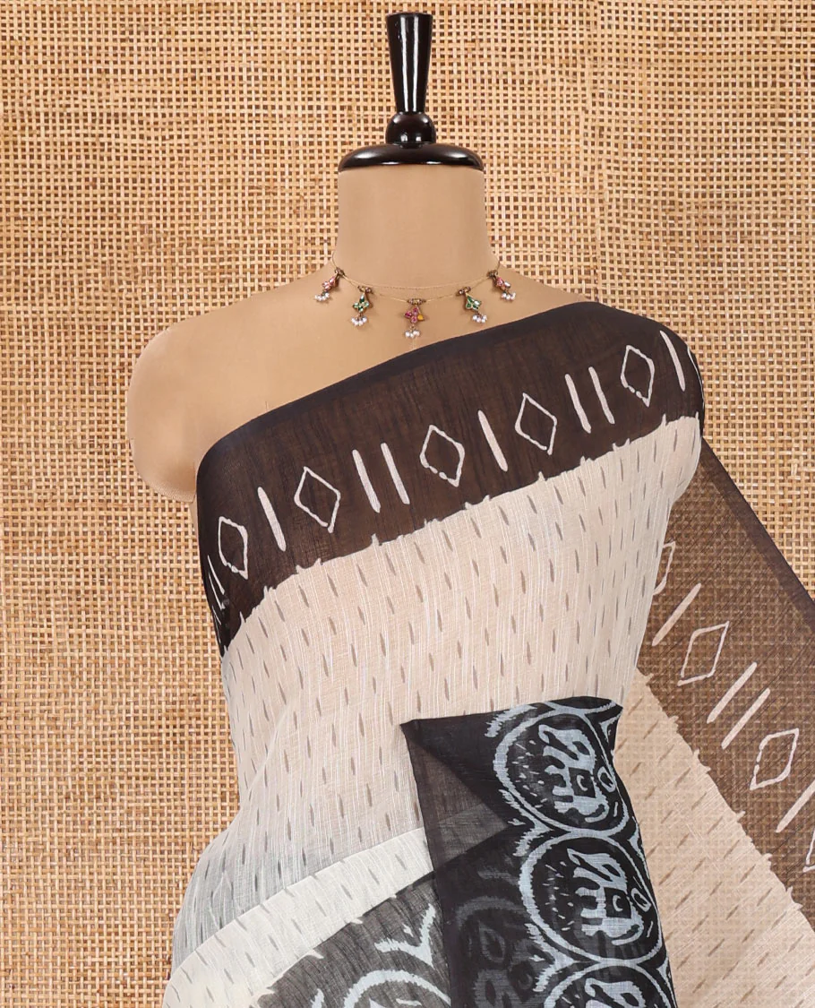 Cream and Black Linen Cotton Saree, Subtly Steeped with Raindrop Style Buttas All Over Its Body, Complemented by Contrast Ikkat Style Border of Elephant Motifs, Ikkat Style Pallu, and Paired with a Contrast Blouse - Image 2