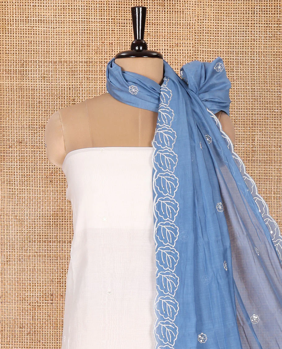 Cream and Blue Mul Chanderi Material Chudidar Set, Delicately Designed with Floral Embroidery On Its Top, A Plain Santoon Bottom, and Comes with a Contrast Scallop Floral Embroidered Dupatta - Image 3