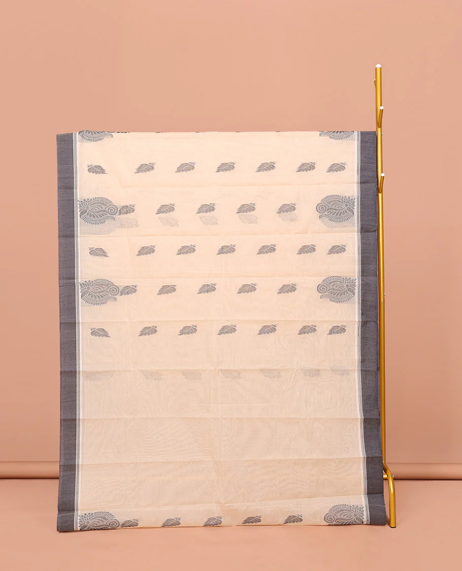 Cream Kanchi Cotton Saree, Embellished with Leaf Buttas All Over Its Body, Complemented by Contrast Border, Pallu of Intricate Designs, and Paired with a Matching Blouse