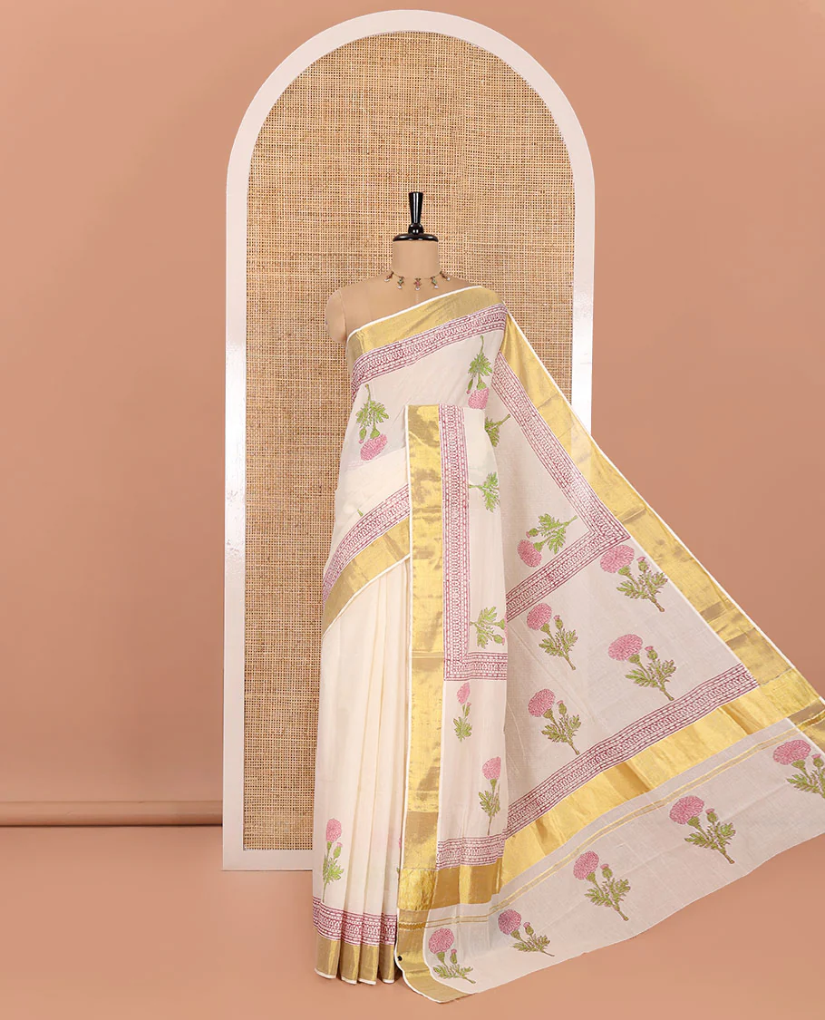 Cream Kerala Cotton Saree, Adorned with Floral Buttas All Over Its Body, Highlighted by Golden Zari Border, Pallu Depicts the Same Floral Print, and Paired with a Matching Floral Printed Blouse