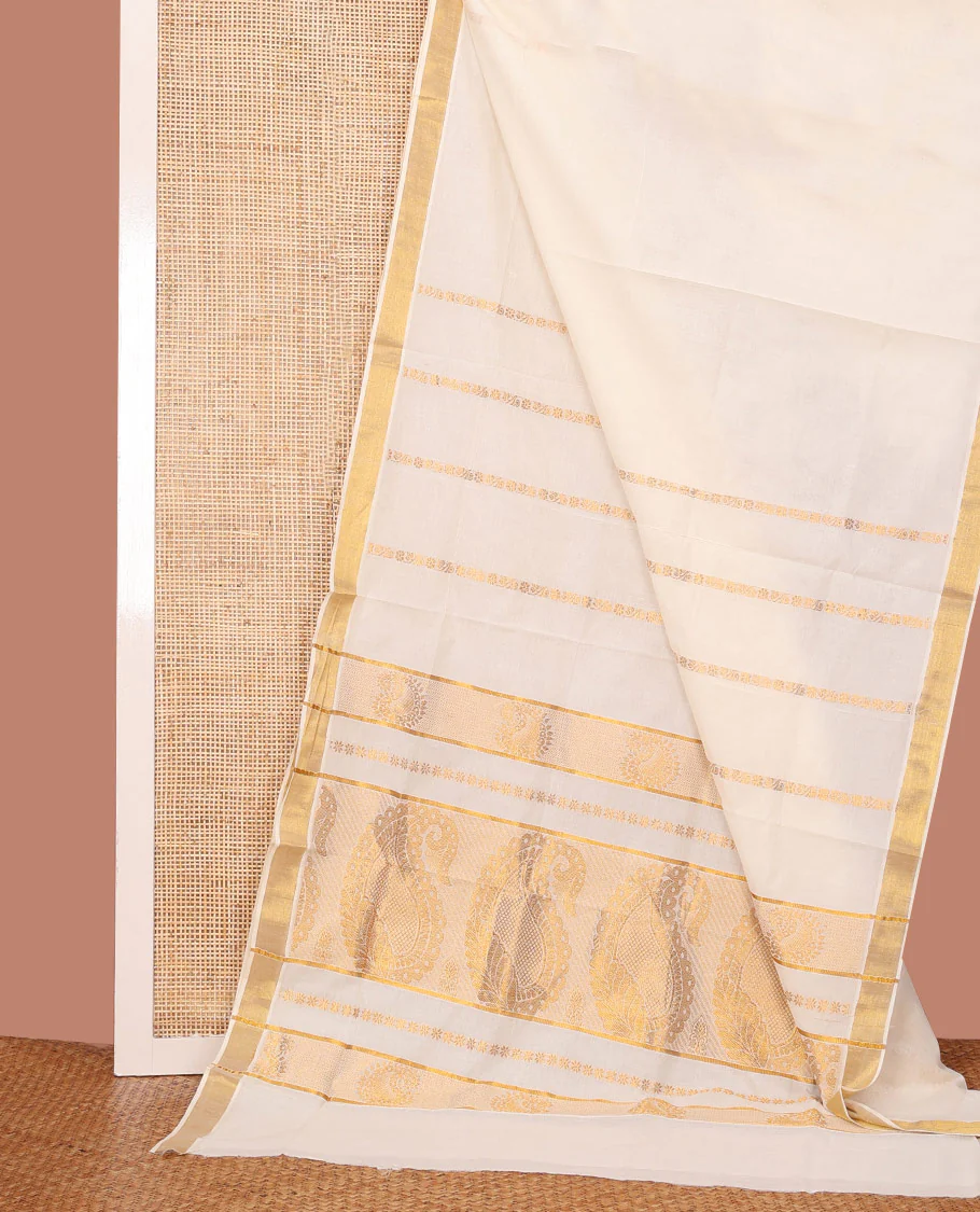 Cream Kerala Cotton Saree Adorned with Zari Stripes All Over Its Body, Zari Bavanji Border, Pallu Features Peacock and Paisley Designs, and Paired with a Matching Blouse