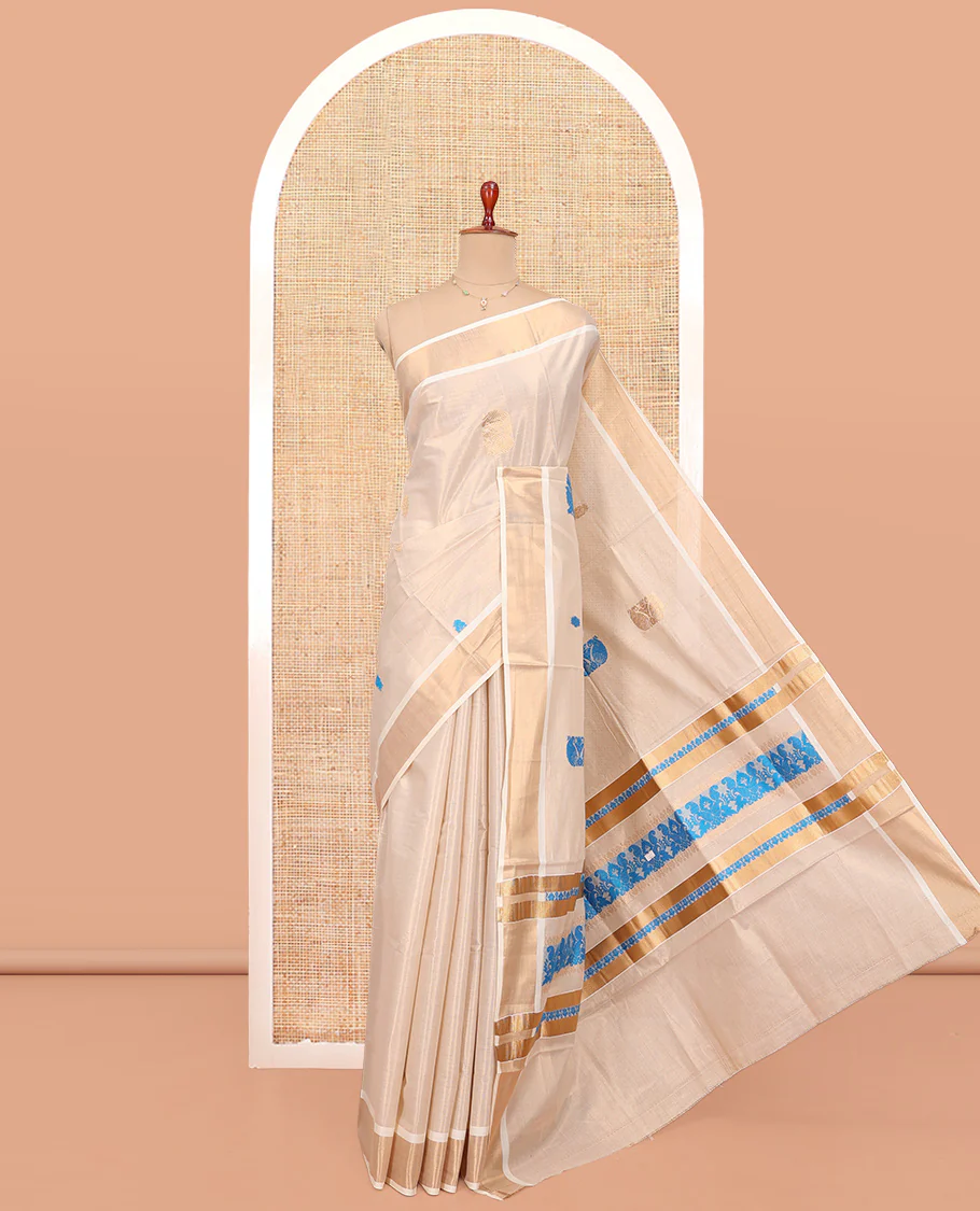 Cream Kerala Cotton Saree, Bedecked with Thread and Zari Buttas All Over Its Body, a Zari Bavanji Border, Pallu of Intricate Designs, and Paired with a Matching Blouse