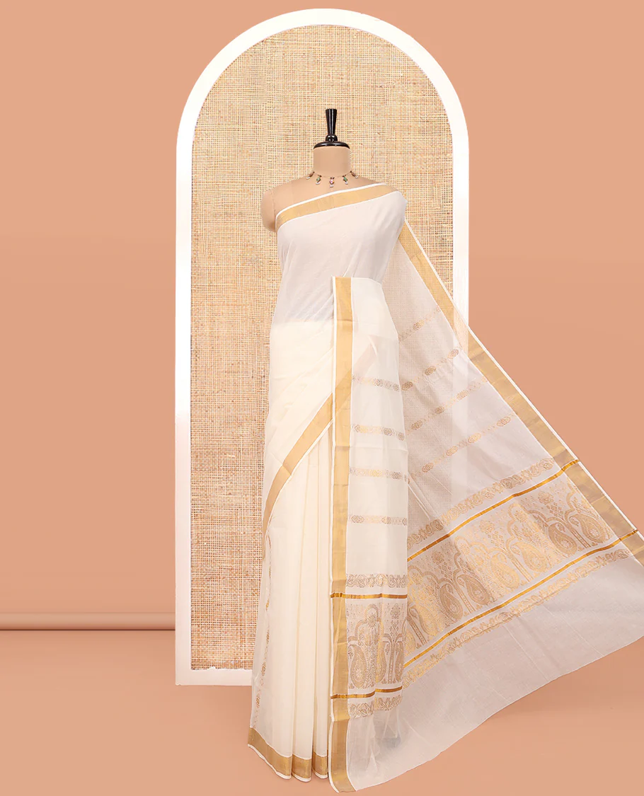 Cream Kerala Cotton Saree, Ornamented with Zari Stripes All Over Its Body, a Subtle Bavanji Border, Pallu of Paisley Designs, and Is Paired with a Matching Blouse