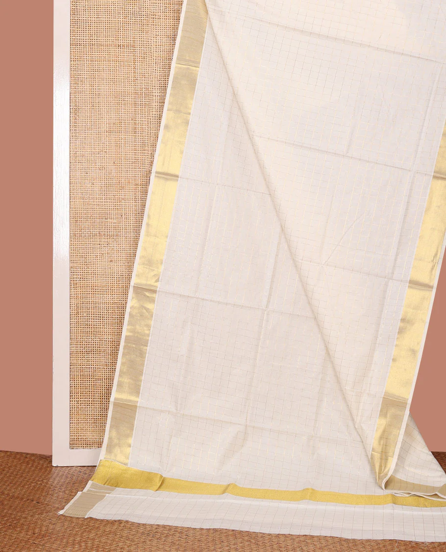 Cream Kerala Cotton Saree Woven with Zari Checks All Over Its Body, Zari Bavanji Border, Gleaming Zari Checked Pallu, and Paired with a Matching Blouse
