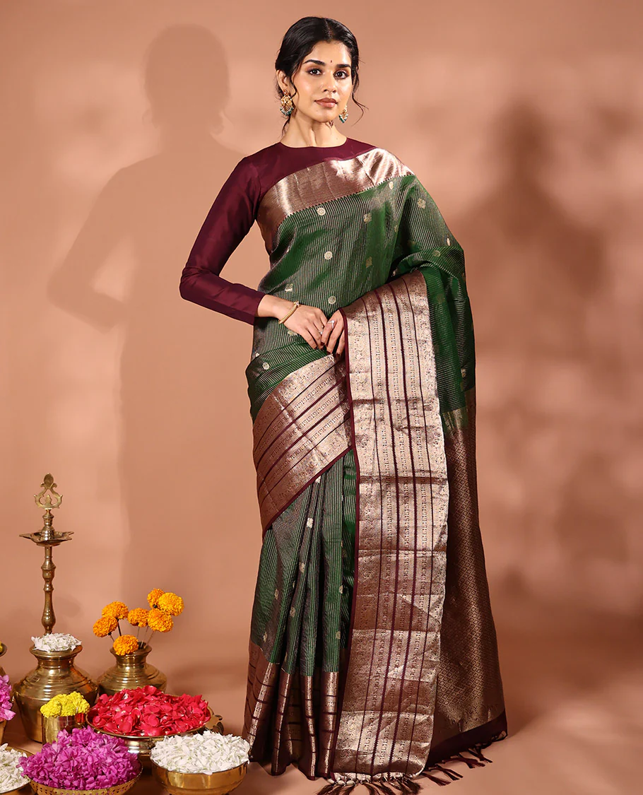 Emerald green striped and annam chakram buttas Vasundhara silk saree, contrast varisai pettu border of rekku, mayil and yaanai designs, and zari rich intricate pallu