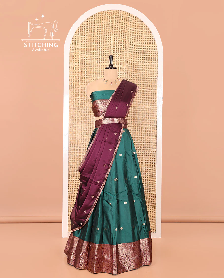 Green and Red Semi-Banarasi Half-Saree, Enriched with Zari Buttas on Its Skirt, Complemented by a Contrast Intricately Zari-Designed Border, Paired with a Matching Blouse, and a Contrast Satin Georgette Embroidered Scallop Dhavani