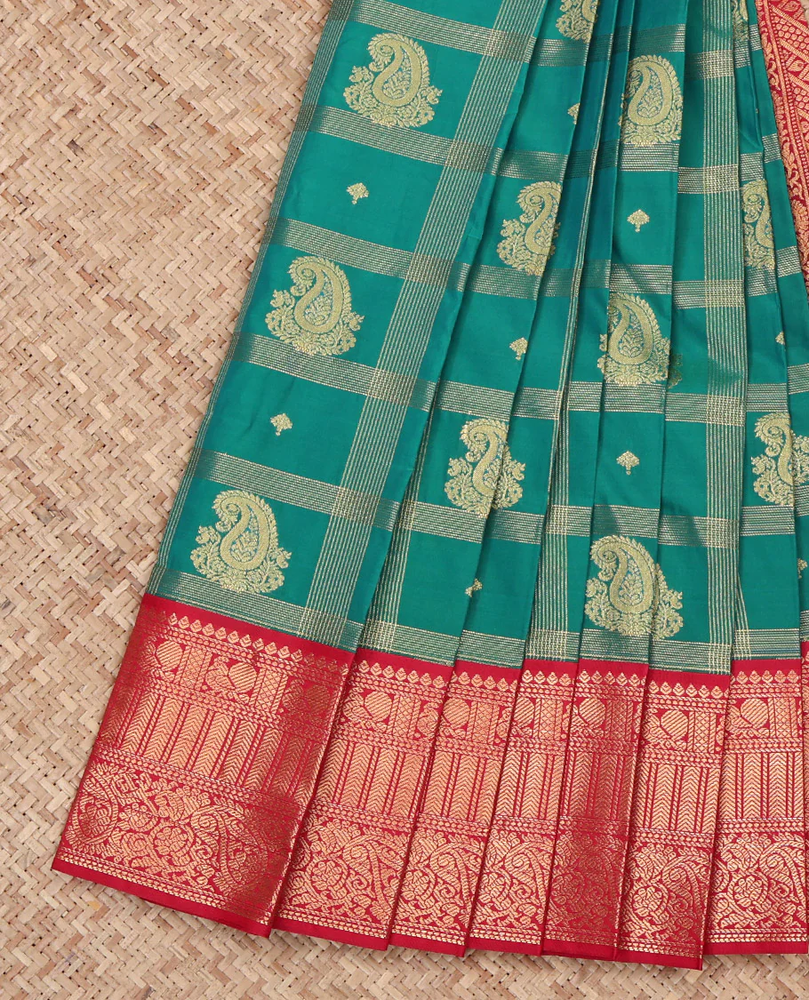 Green Budget Silk Saree, Decked Up with Paisley Butta Enclosed Checks on Its Body, Complemented by a Contrast Traditional Zari Design Border, Grandly Decked Up Pallu, and Paired with a Contrast Blouse