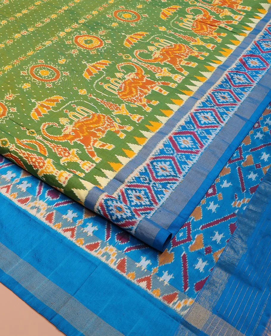 Green Ikkat Silk Saree, Enriched with Elephant Motifs Ikkat Weave All Over Its Body, Complemented by a Contrast Temple Border of Diamond Designs, Pallu of Ikkat Designs, and Paired with a Contrast Blouse - Image 2