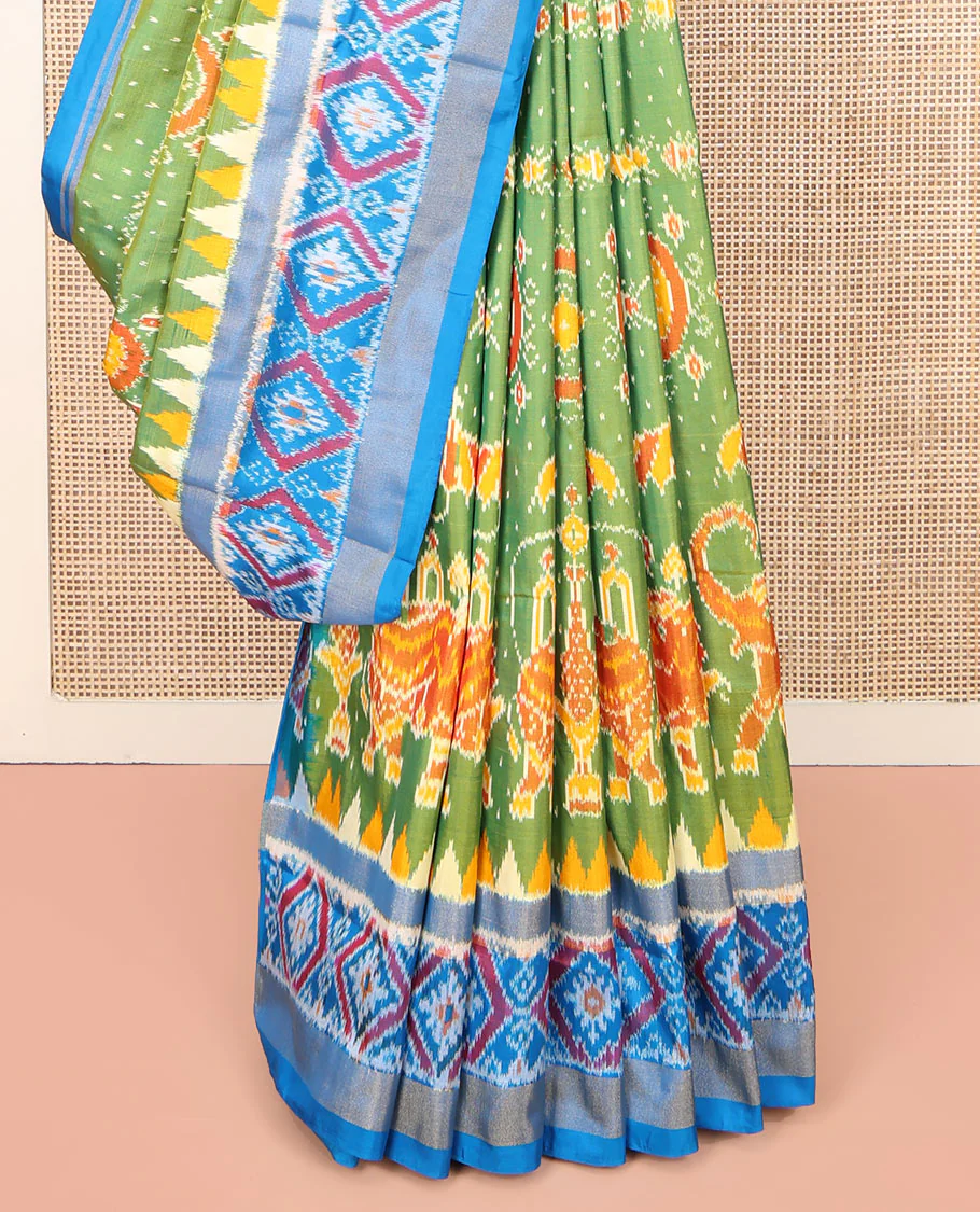 Green Ikkat Silk Saree, Enriched with Elephant Motifs Ikkat Weave All Over Its Body, Complemented by a Contrast Temple Border of Diamond Designs, Pallu of Ikkat Designs, and Paired with a Contrast Blouse - Image 4