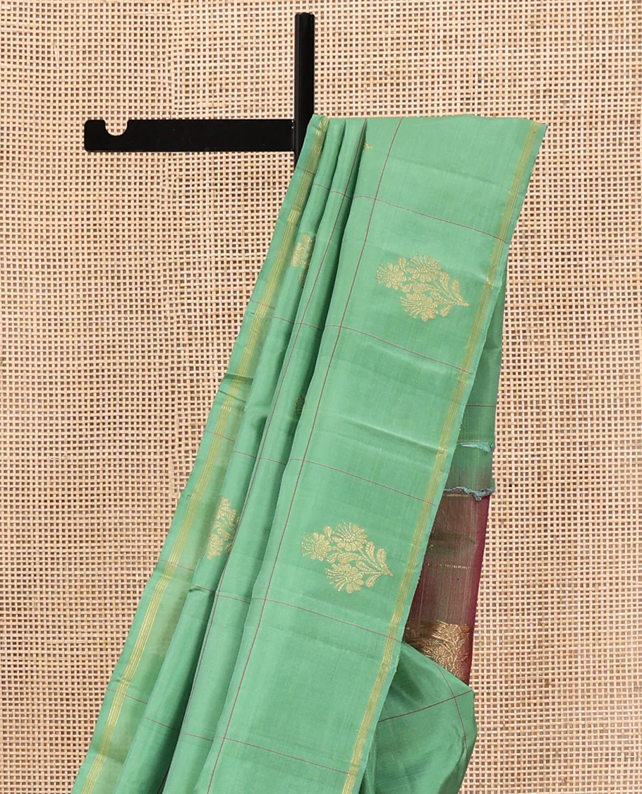 Green Kanchipuram Silk Saree, Beautifully Woven with Floral Butta Enclosed, Checked All Over Its Body, Subtle Zari Piping Border, Captivating Pallu of Intricate Designs, and Paired with a Contrast Blouse - Image 3