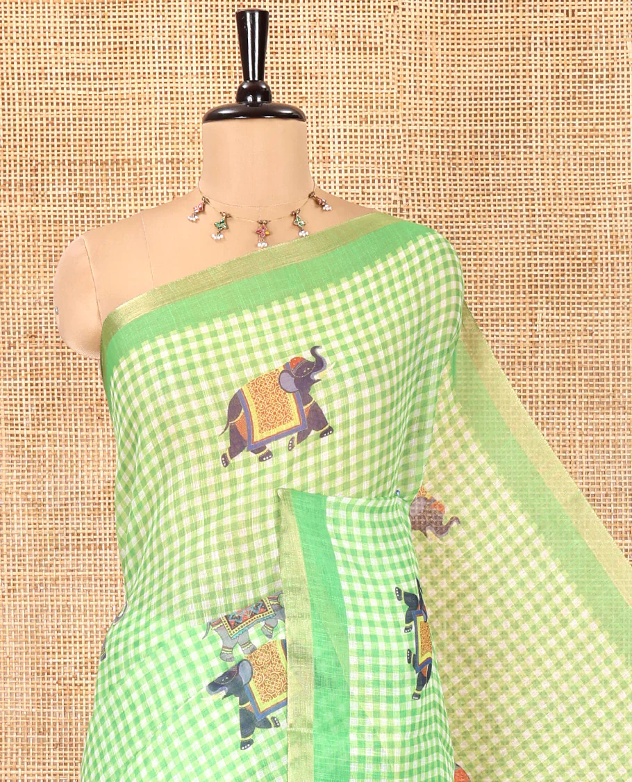 Green Linen Cotton Saree, Decked Up with Micro-Checks and Elephant Motifs on Its Body, Complemented by a Contrast Border, Striped Pallu, and Paired with a Contrast Elephant Motifs Printed Blouse - Image 2