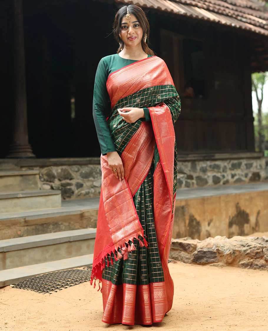 Green mayil chakram with zari checked Vasundhara silk saree, contrast intricate pallu, and border of thilakam mokku, diamond, and iruthalai pakshi designs
