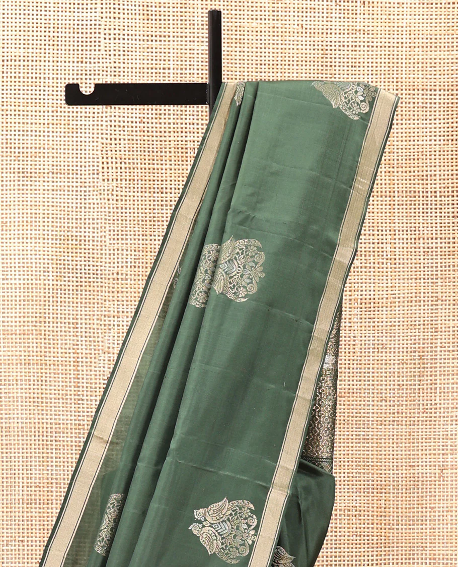 Green Mayuri Soft Silk Saree, Entralled with Zari Buttas All Over Its Body Highlighted iby Zari Piping Border, Intricately Designed Pallu and Paired with a Matching Blouse - Image 3