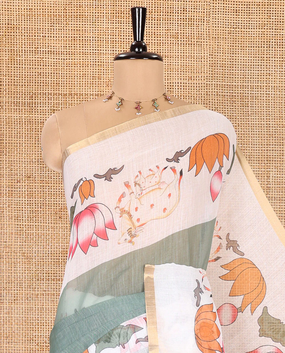 Green Plain Linen Cotton Saree, Complemented by a Contrast Border Depicting Pichwai Cow and Lotus Motifs Print, Pallu of the Same Body Print, and Paired with a Contrast Blouse - Image 2