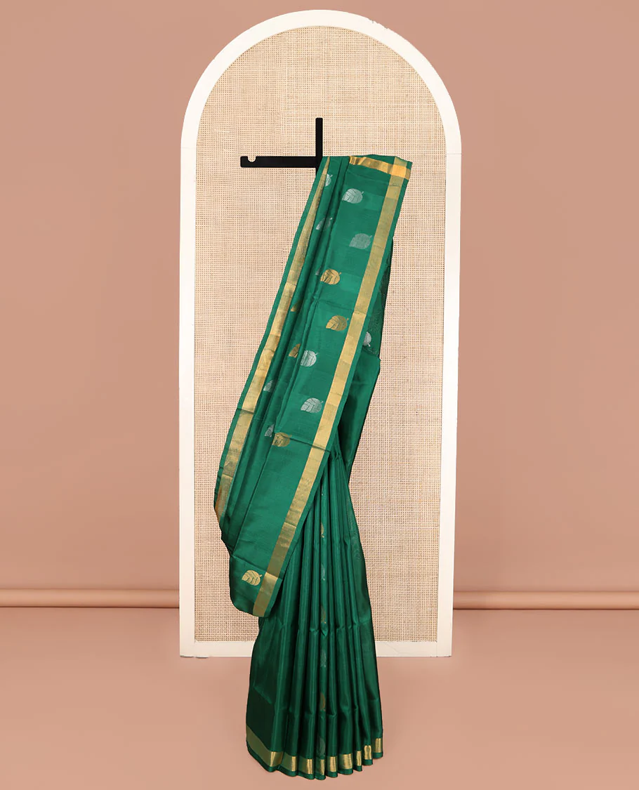 Green Uppada Silk Saree, Subtly Sparkled with Leaf Zari Buttas All Over Its Body, Subtle Bavanji Border, Pallu Steeped with Leaf Buttas, and Paired with a Matching Blouse