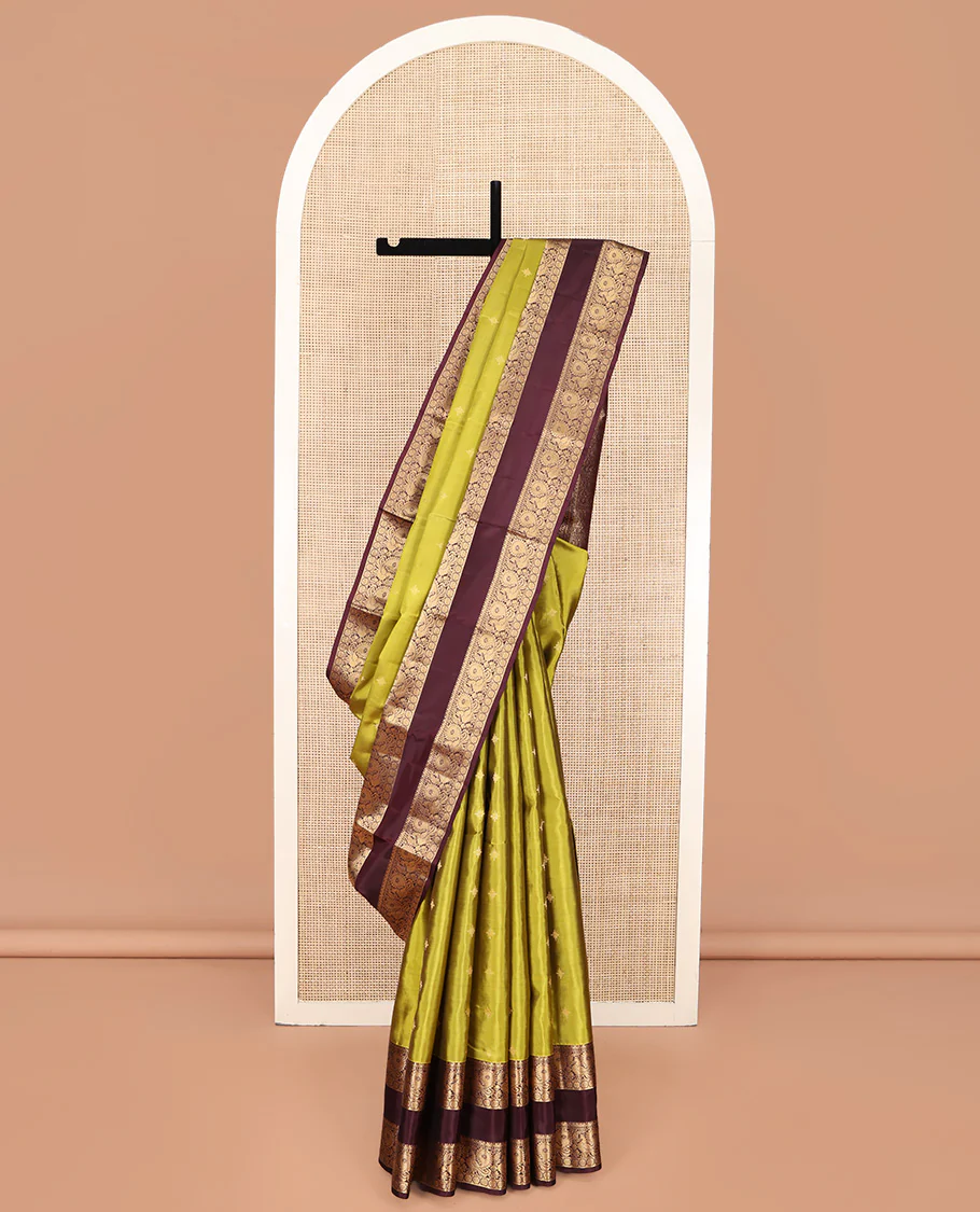 Green Vasundhara Lite Silk Mix Saree, Finely Crafted with Zari Buttas on Its Body, Complemented by Contrast Rettai Pettu Border of Mayil and Laddu Kamalam Designs, Pallu Mirrors the Same Designs, and Paired with a Contrast Blouse