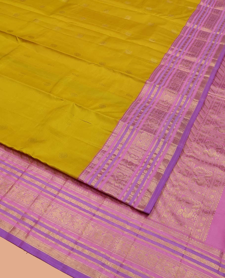 Green Vasundhara Silk Saree, Sparsely Threaded with Zari Buttas All Over Its Body, Complemented by a Contrast Border of Rekku, Muthu, Kathir, Poun, Mayil, and Mayil Kann Designs, Grandly Decked Up Pallu, and Paired with a Contrast Blouse - Image 2