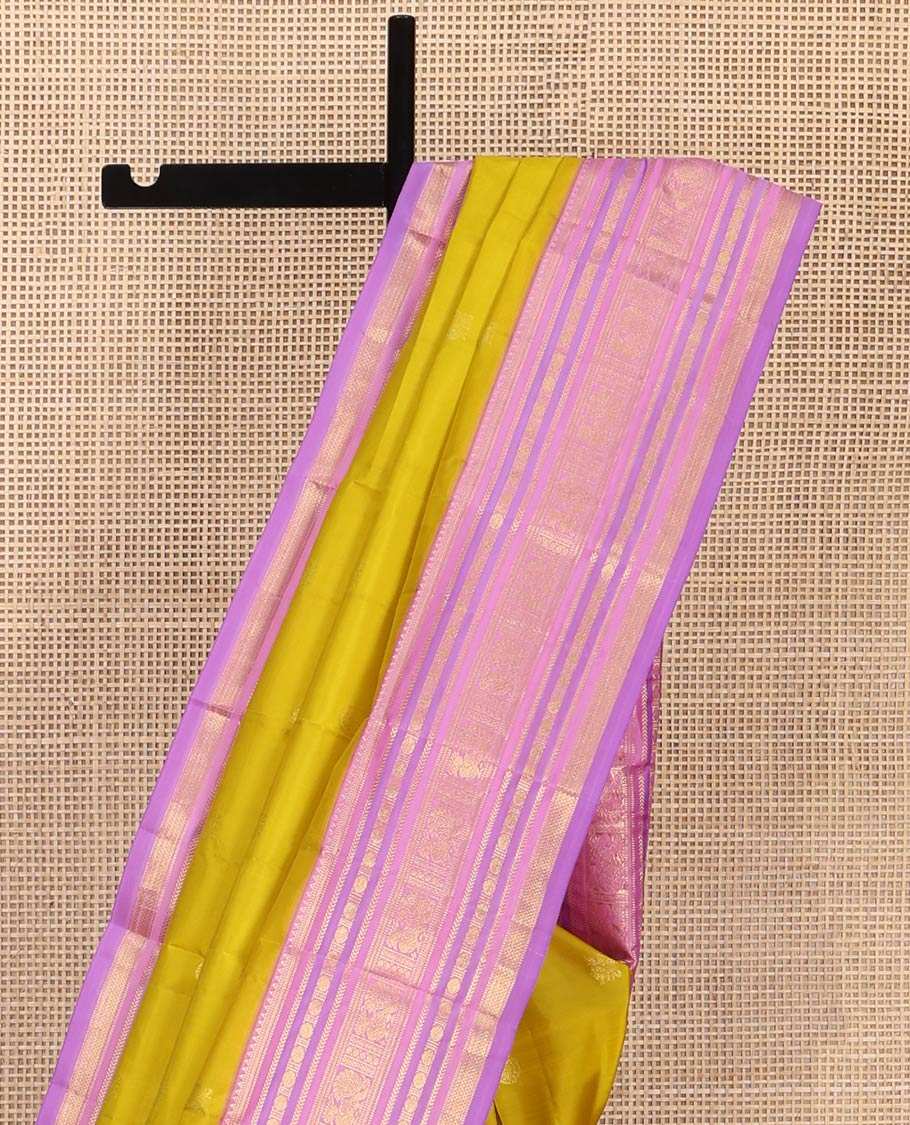 Green Vasundhara Silk Saree, Sparsely Threaded with Zari Buttas All Over Its Body, Complemented by a Contrast Border of Rekku, Muthu, Kathir, Poun, Mayil, and Mayil Kann Designs, Grandly Decked Up Pallu, and Paired with a Contrast Blouse - Image 3