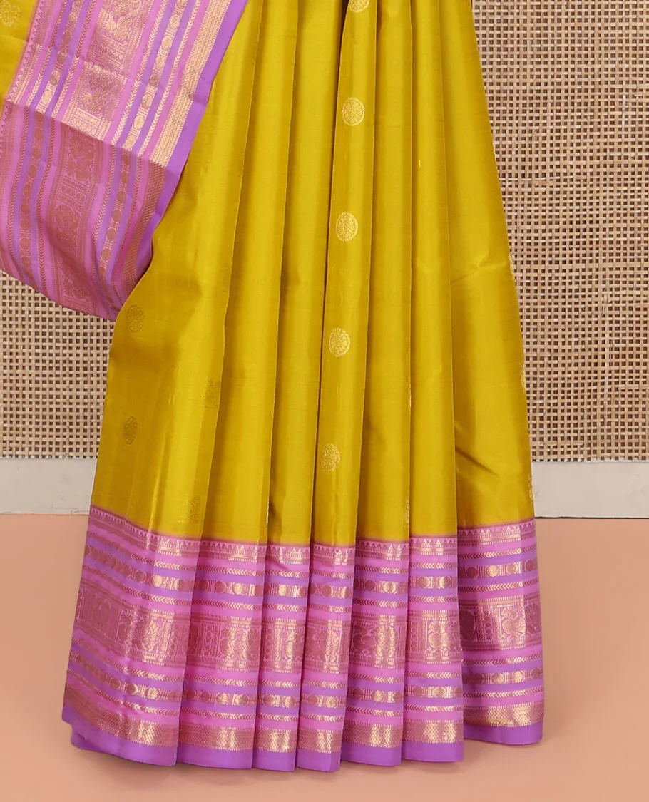 Green Vasundhara Silk Saree, Sparsely Threaded with Zari Buttas All Over Its Body, Complemented by a Contrast Border of Rekku, Muthu, Kathir, Poun, Mayil, and Mayil Kann Designs, Grandly Decked Up Pallu, and Paired with a Contrast Blouse - Image 4