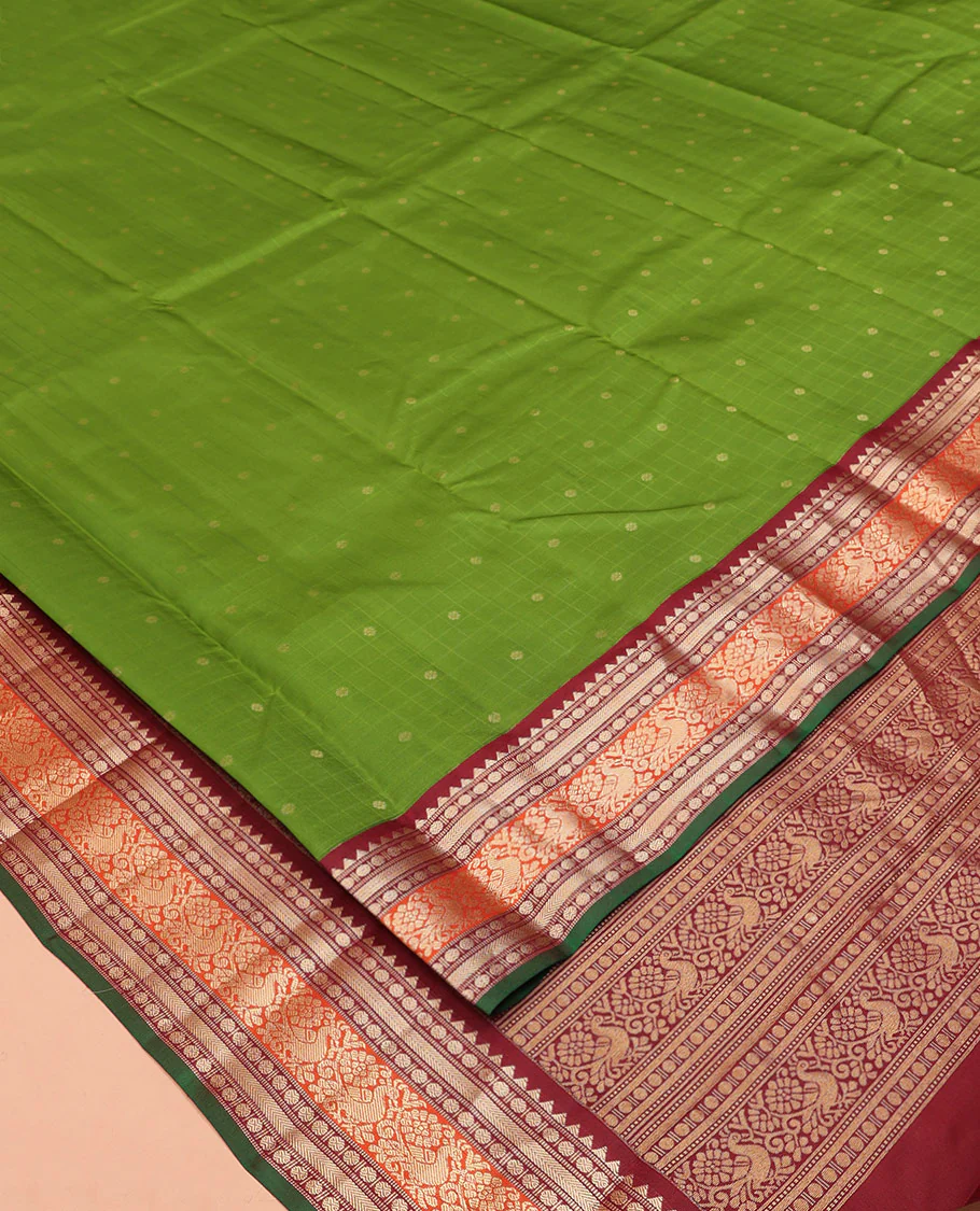 Green Vasundhara Silk Saree, Sparsely Woven with Zari Buttas All Over Its Body, Complemented by a Contrast Border of Rekku, Poun, Kathir, and Mayil Designs, Pallu Steeped with the Same Border Designs, and Paired with a Contrast Blouse - Image 2