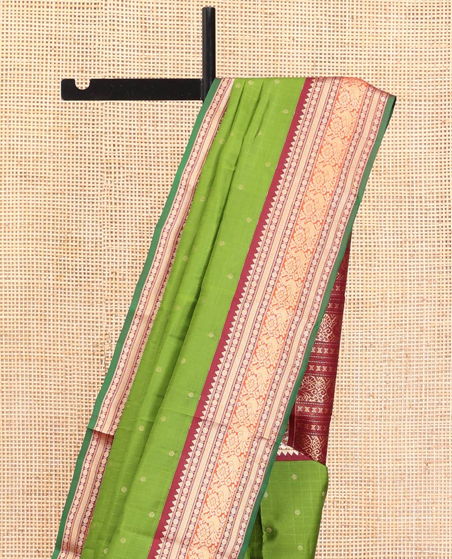 Green Vasundhara Silk Saree, Sparsely Woven with Zari Buttas All Over Its Body, Complemented by a Contrast Border of Rekku, Poun, Kathir, and Mayil Designs, Pallu Steeped with the Same Border Designs, and Paired with a Contrast Blouse - Image 3