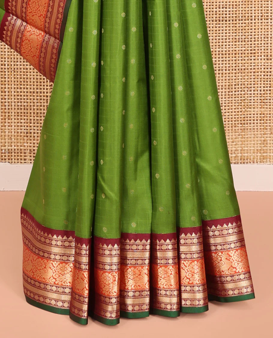 Green Vasundhara Silk Saree, Sparsely Woven with Zari Buttas All Over Its Body, Complemented by a Contrast Border of Rekku, Poun, Kathir, and Mayil Designs, Pallu Steeped with the Same Border Designs, and Paired with a Contrast Blouse - Image 4