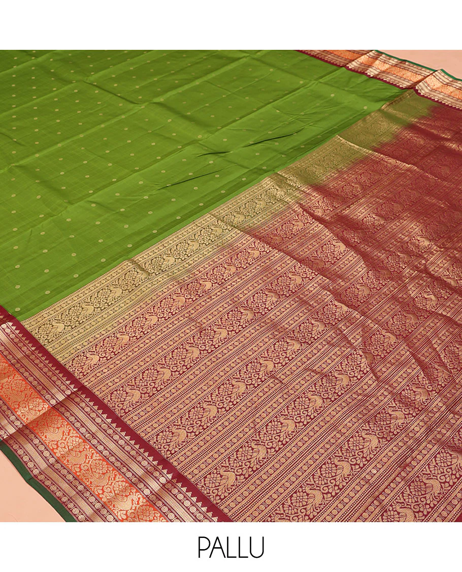 Green Vasundhara Silk Saree, Sparsely Woven with Zari Buttas All Over Its Body, Complemented by a Contrast Border of Rekku, Poun, Kathir, and Mayil Designs, Pallu Steeped with the Same Border Designs, and Paired with a Contrast Blouse - Image 5