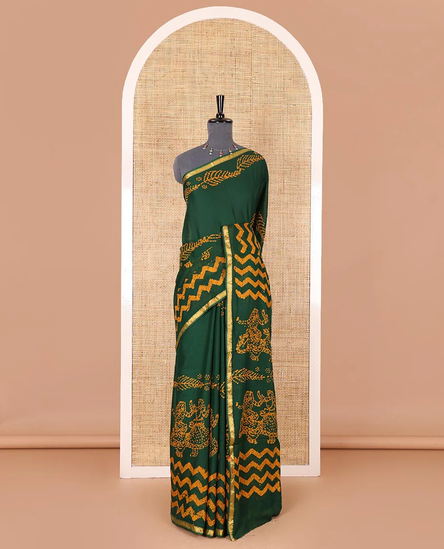 Green wax batik-style zig-zag printed pure cotton saree, gold zari piping border, human figurines batik printed pallu, and a matching blouse - Image 2