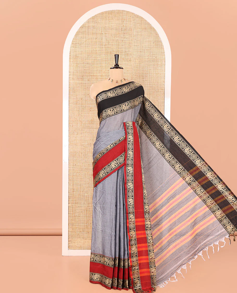 Grey Plain Mercerised Cotton Saree, Complemented by a Contrast Ganga-Jamuna Rettai Pettu Thread Border of Temple, Elephant, and Chakram Designs, Subtly Striped Pallu, and Paired with a Matching Blouse