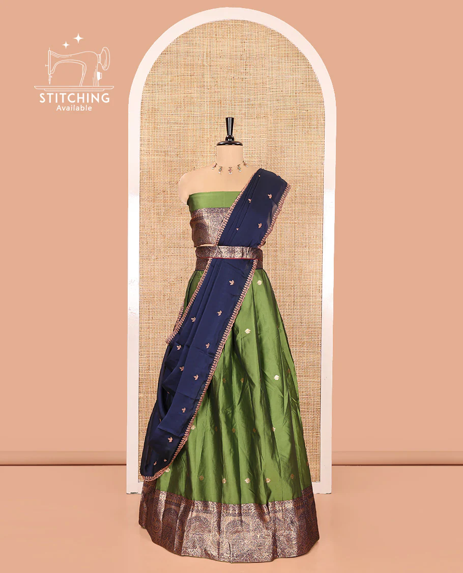 Leaf Green and Blue Semi-Banarasi Half-Saree, Beautifully Woven with Zari Buttas on Its Skirt, Complemented by a Contrast Geometric Patterns Zari Woven Border, Paired with a Matching Blouse, and a Contrast Satin Georgette Embroidered Scallop Dhavani