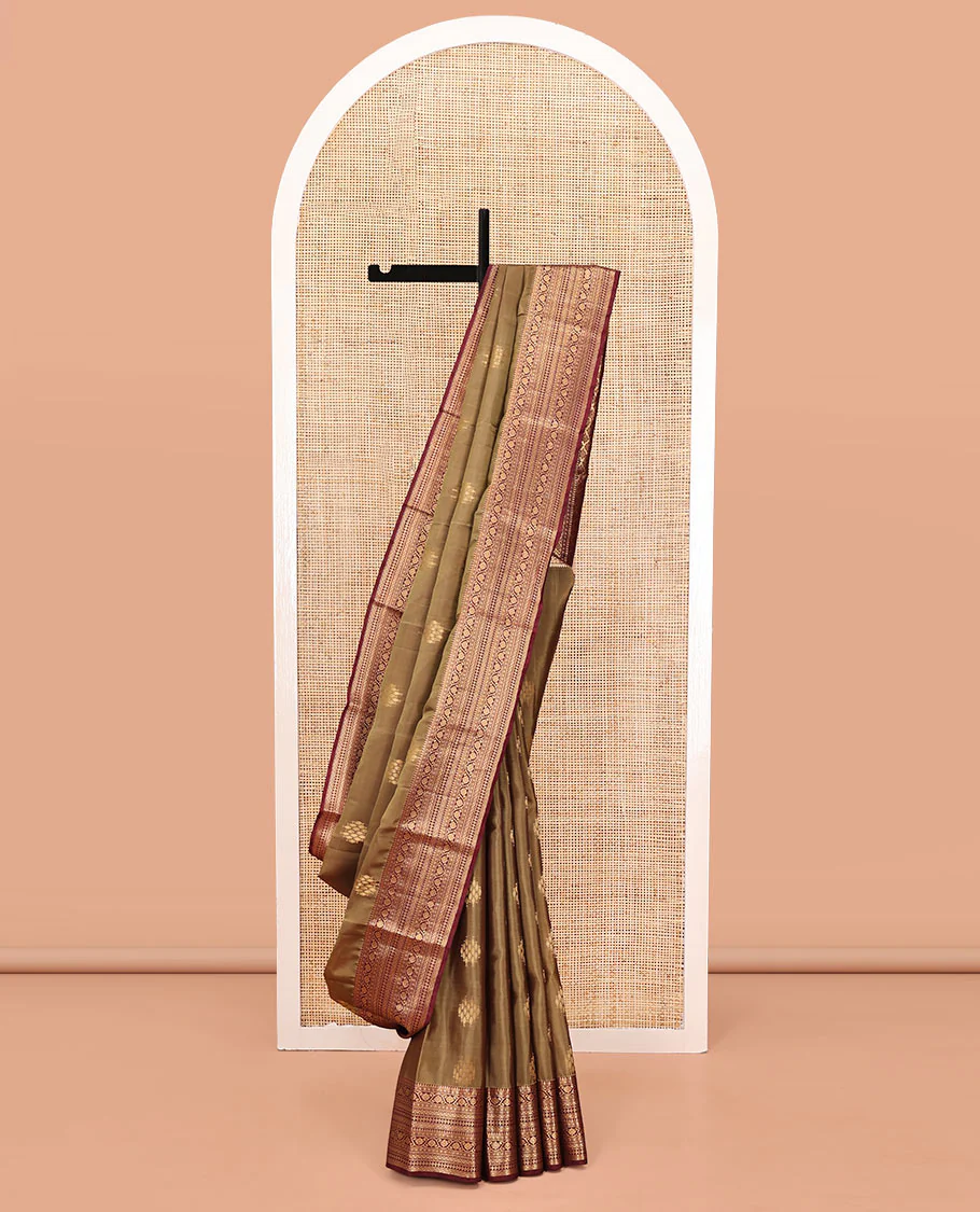 Light Brown Vasundhara Lite Silk Mix Saree, Ornamented With Zari Buttas All Over Its Body, Complemented by Contrast Border of Thilakam Mokku, Kodi Visiry, Neli, Diamond, and Paiyadi Kattam, Grand Pallu and Paired with a Contrast Blouse