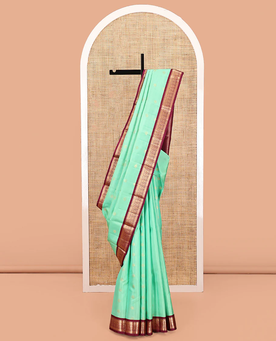 Light Turquoise Vasundhara Silk Saree, Sparsely Woven with Zari Buttas All Over Its Body, Complemented by a Contrast Border of Rekku, Muthu, Kathir, and Kodi Visiry Designs, Grand Jaal Pallu, and Paired with a Contrast Blouse