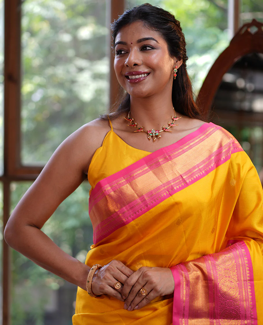 Mango Yellow Vasundhara Silk Saree, Subtly Sparkled with Sparse Stripes and Zari Buttas, Complemented by a Contrast Border of Thilakam, Banaras, Muthu, and Round Mayil Designs, Pallu Steeped with Traditional Designs, and Paired with a Contrast Blouse - Image 3